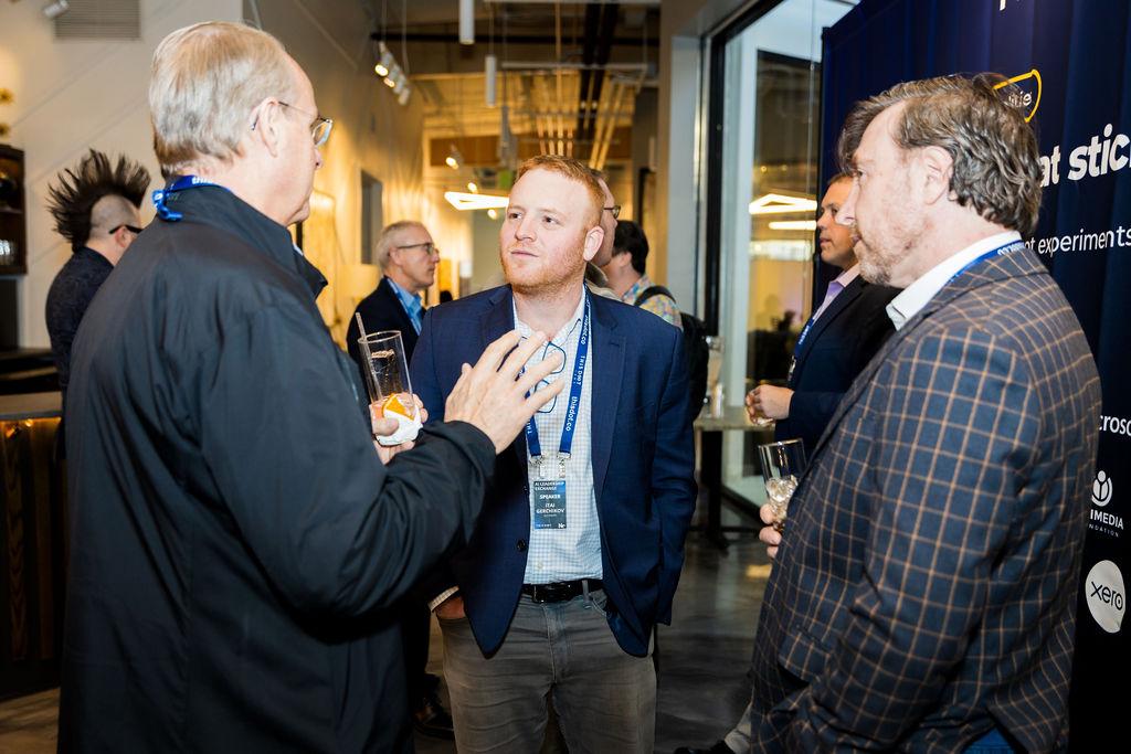 Three leaders in conversation between sessions
